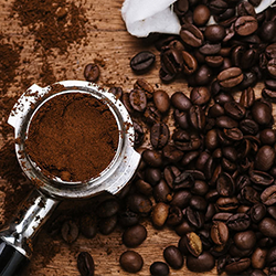 Ground coffee in an espresso machine thingee that you push the hot water through, and its surrounded by coffee beans.